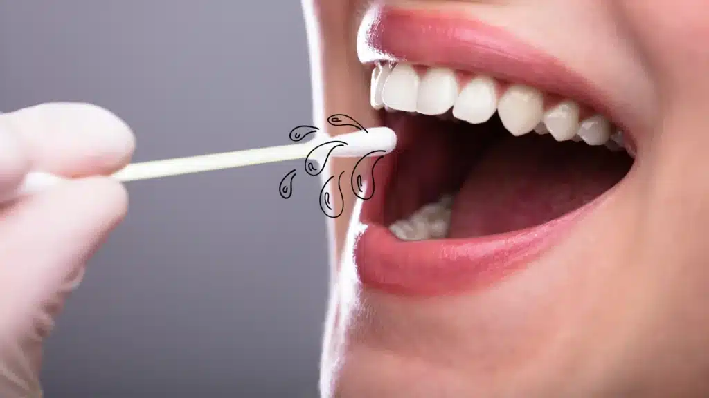 dental professional swabbing a patient's mouth for saliva testing